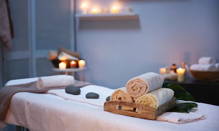 Spa towels and hot stones setup for treatment
